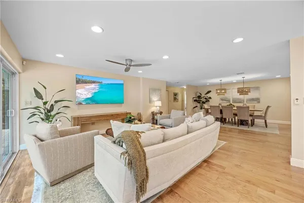 a living room with furniture and view of kitchen