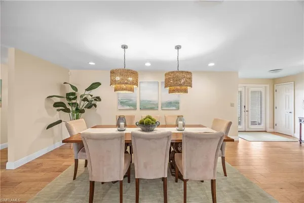 a view of a dining room with furniture wooden floor and chandelier