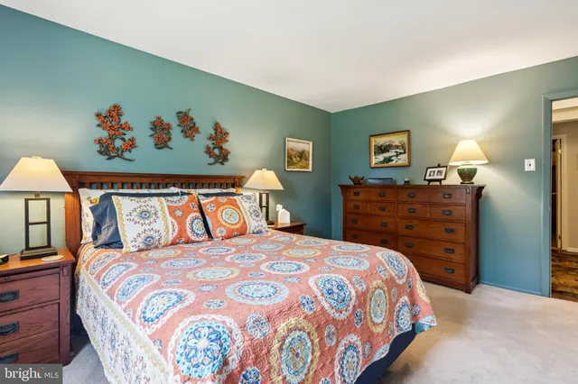 a bedroom with a bed and a dresser in it