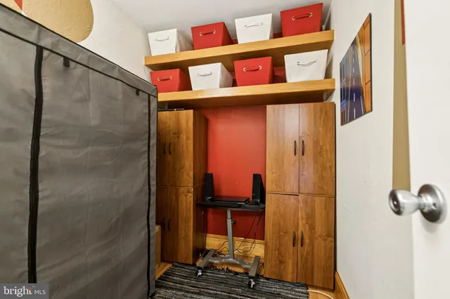 a bathroom with a refrigerator and a shower