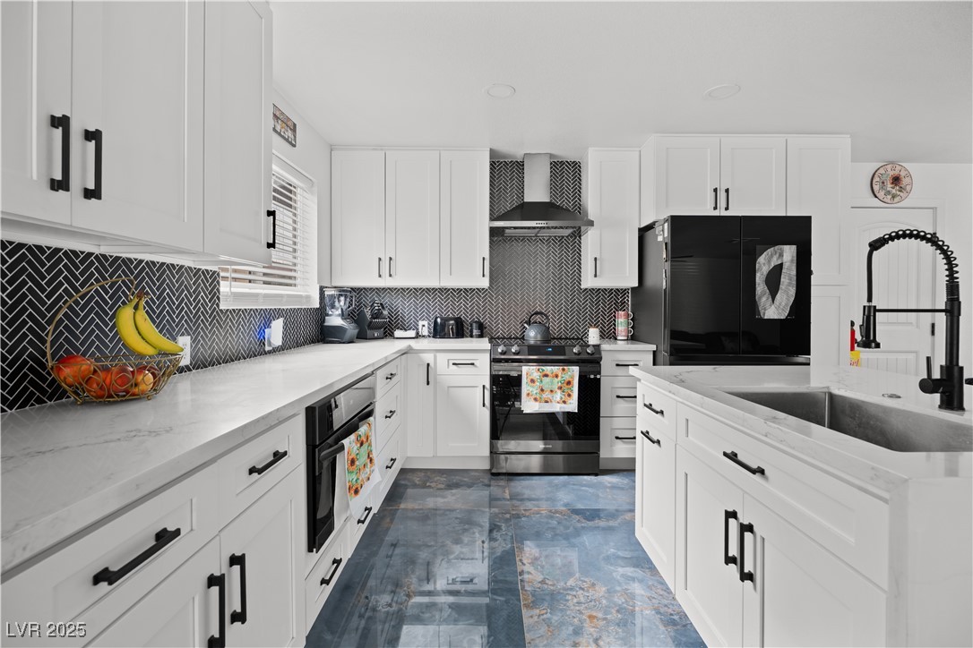 4231 Rimcrest Road Las Vegas, NV 89121 - Photo 15 of 52 Kitchen featuring refrigerator, tasteful backsplash, stainless steel range with electric stovetop, wall chimney exhaust hood, and white cabinets