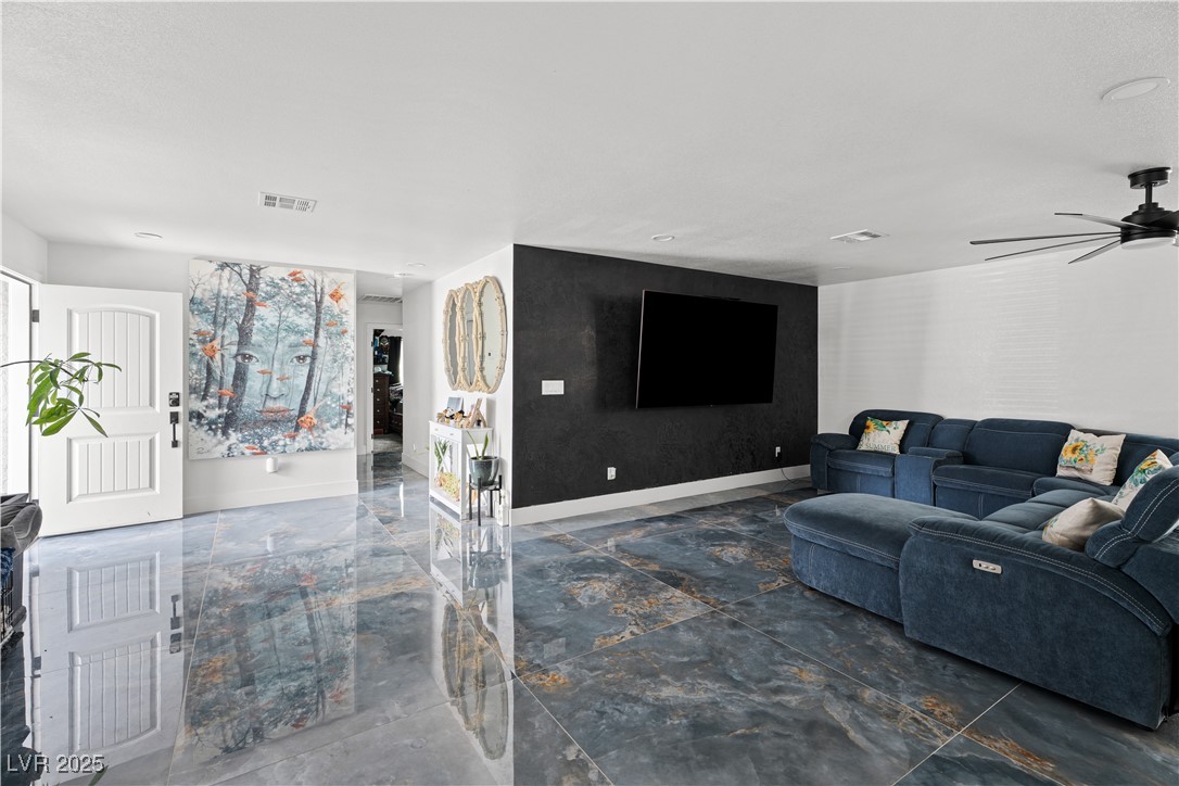 4231 Rimcrest Road Las Vegas, NV 89121 - Photo 18 of 52 Living area with baseboards and a ceiling fan