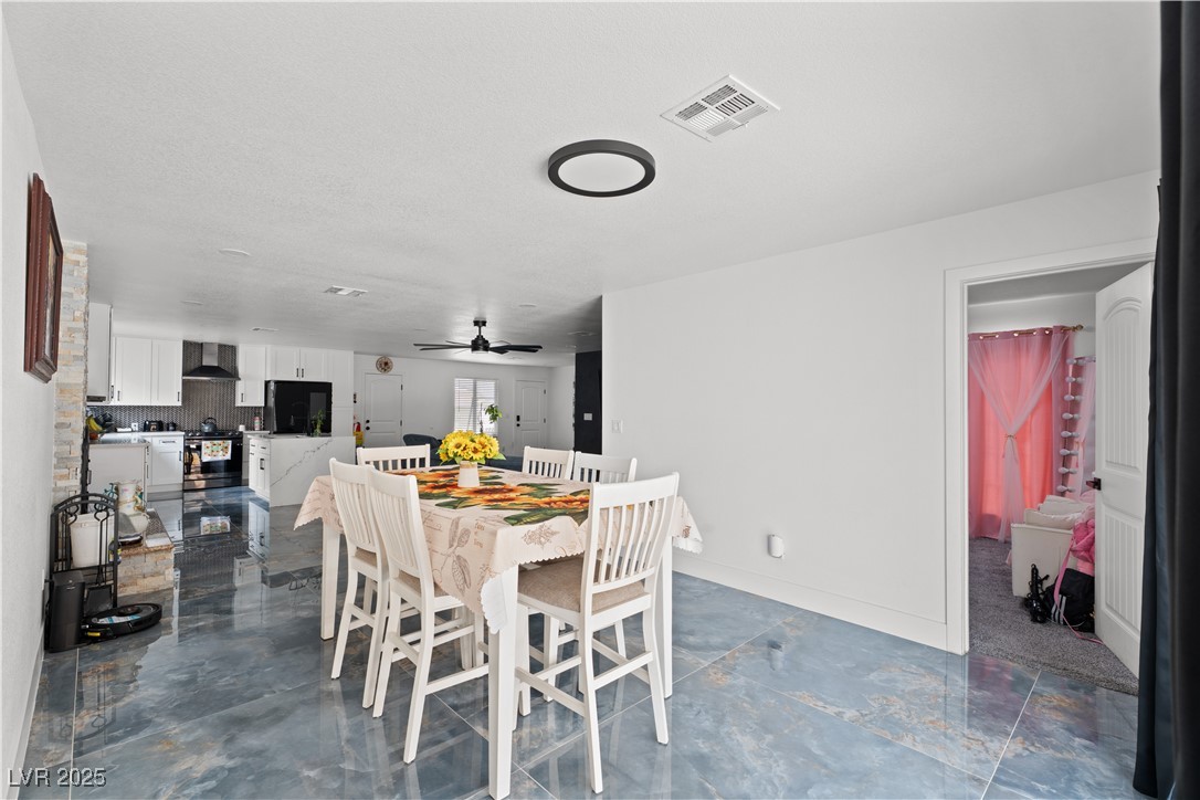 4231 Rimcrest Road Las Vegas, NV 89121 - Photo 23 of 52 Dining area with ceiling fan and baseboards