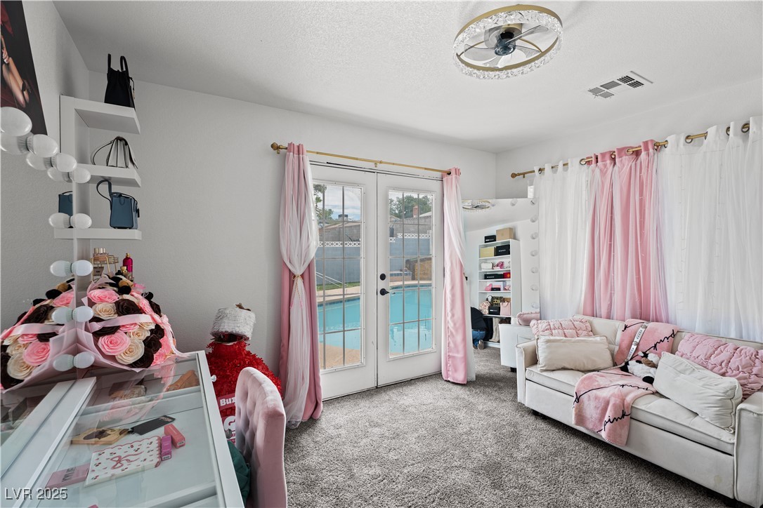 4231 Rimcrest Road Las Vegas, NV 89121 - Photo 25 of 52 Living room with french doors and carpet floors