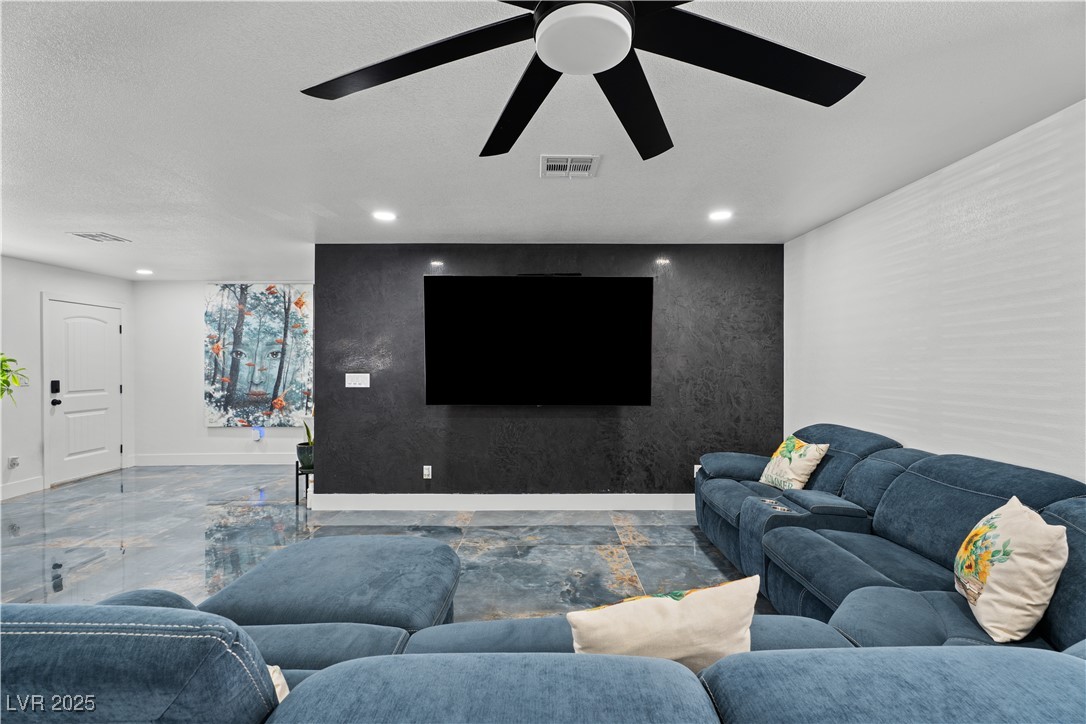 4231 Rimcrest Road Las Vegas, NV 89121 - Photo 26 of 52 Living room with recessed lighting, a ceiling fan, and a textured ceiling