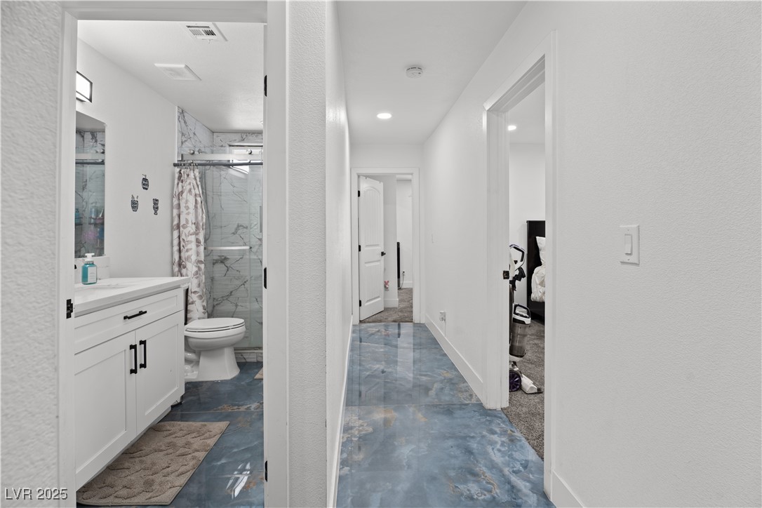 4231 Rimcrest Road Las Vegas, NV 89121 - Photo 28 of 52 Full bath with vanity, a marble finish shower, and a textured wall