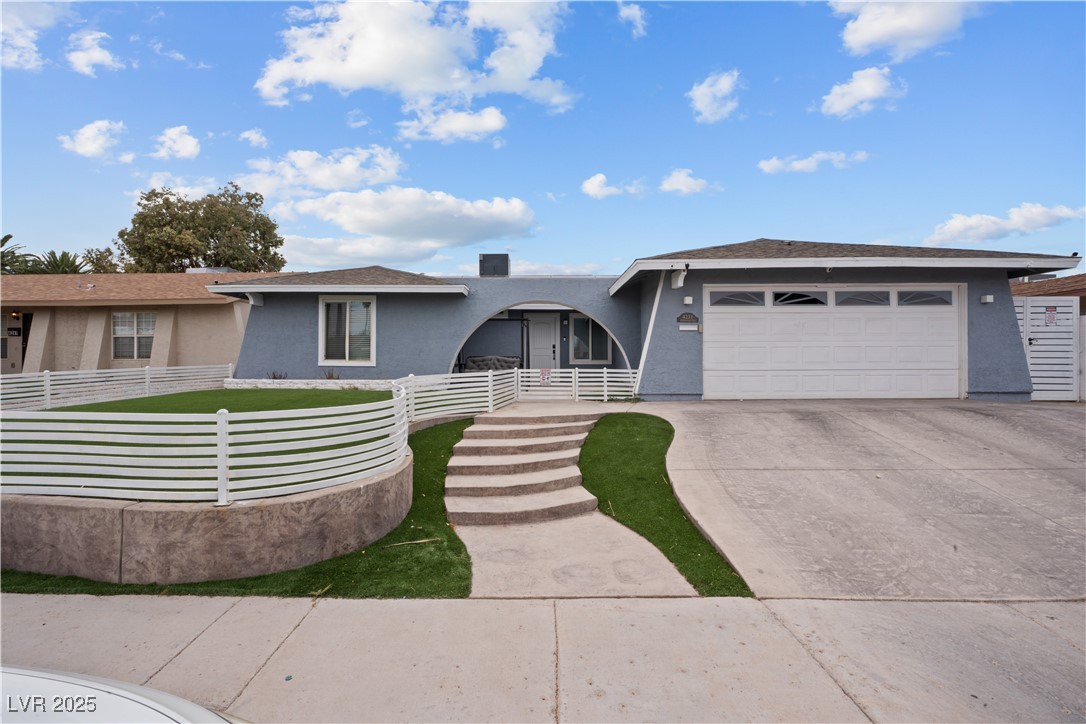 4231 Rimcrest Road Las Vegas, NV 89121 - Photo 3 of 52 View of front of home featuring stucco siding, an attached garage, and concrete driveway