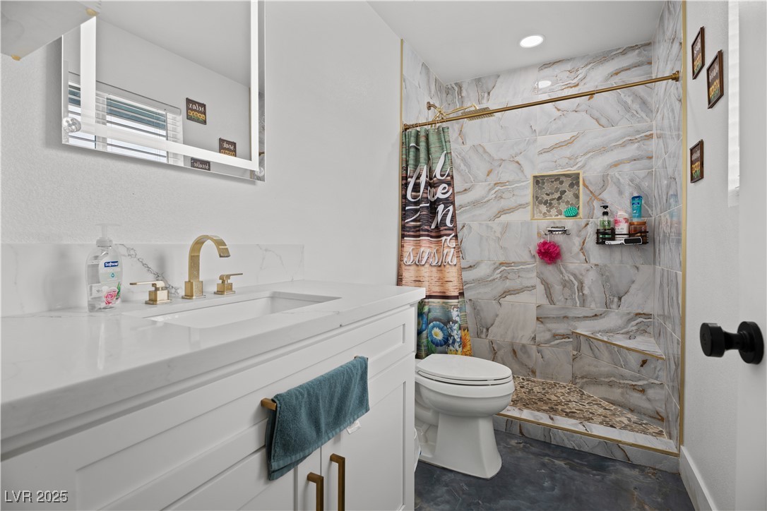 4231 Rimcrest Road Las Vegas, NV 89121 - Photo 37 of 52 Bathroom featuring vanity and a tile shower