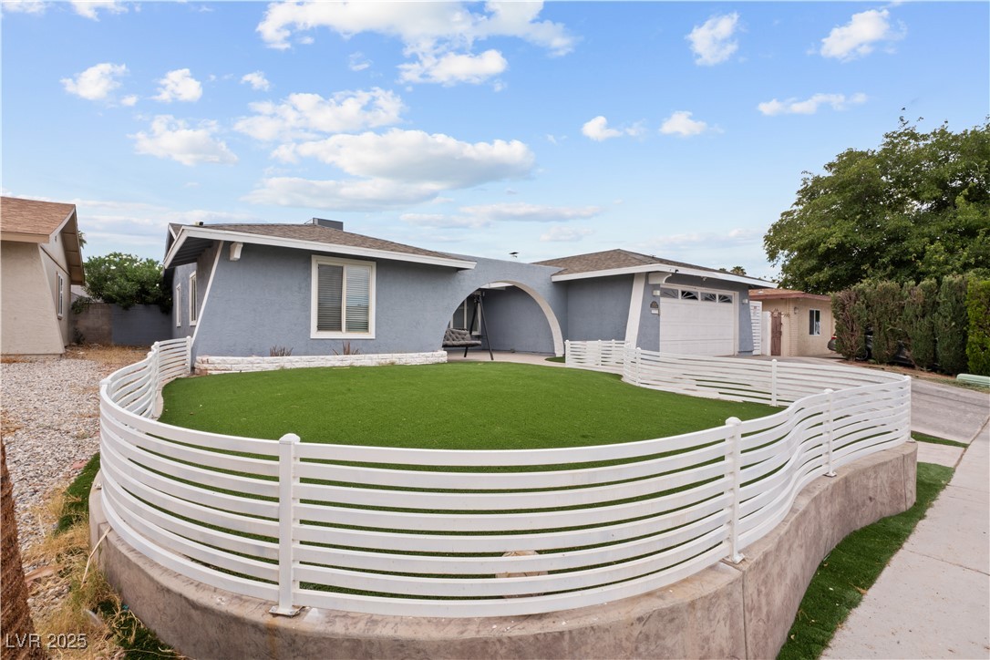 4231 Rimcrest Road Las Vegas, NV 89121 - Photo 4 of 52 Ranch-style house with a garage, stucco siding, and driveway