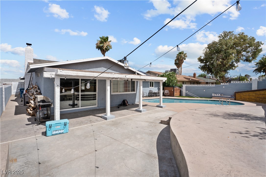 4231 Rimcrest Road Las Vegas, NV 89121 - Photo 41 of 52 Back of house with a fenced backyard, a patio area, and a chimney