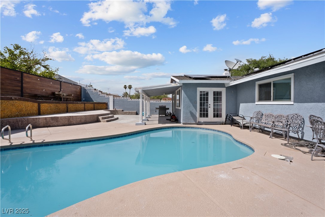 4231 Rimcrest Road Las Vegas, NV 89121 - Photo 44 of 52 View of pool featuring french doors, a patio, and a fenced backyard