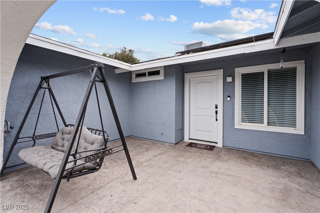 4231 Rimcrest Road Las Vegas, NV 89121 - Photo 7 of 52 Doorway to property featuring stucco siding and a patio area