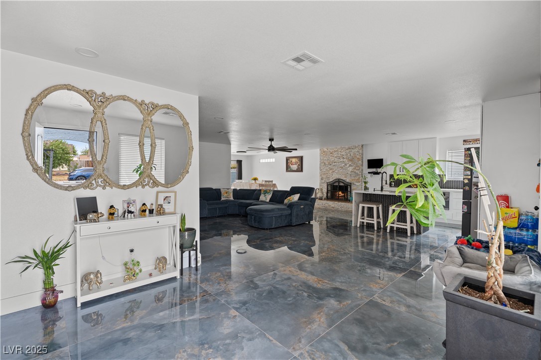 4231 Rimcrest Road Las Vegas, NV 89121 - Photo 9 of 52 Living area featuring marble tiled floors, a fireplace, and ceiling fan