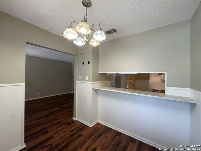 a view of chandelier and wooden floor