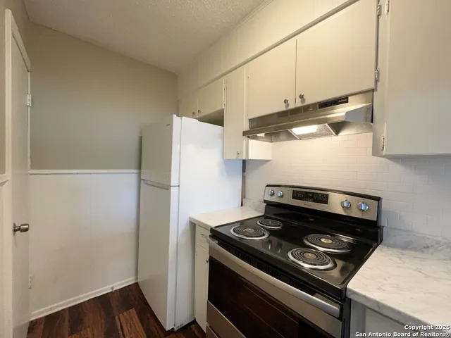 a kitchen with a stove and a refrigerator
