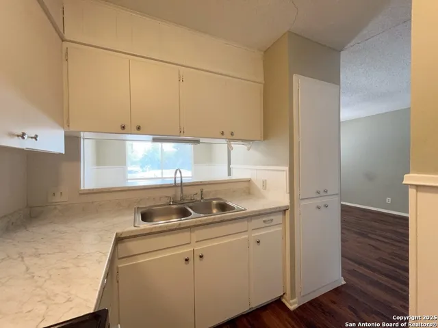 a kitchen with a sink and cabinets
