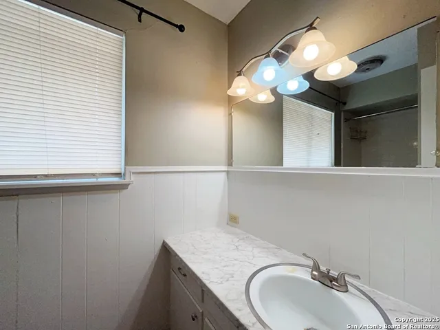 a bathroom with a sink and a mirror