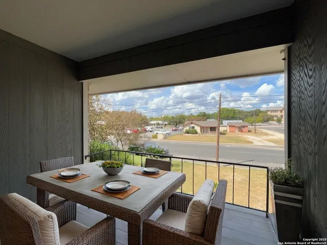 a view of a city from a dining room with furniture and window