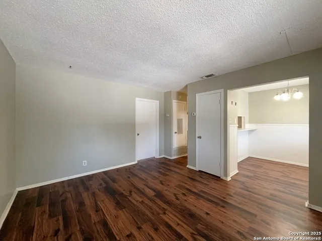 a view of an empty room and wooden floor