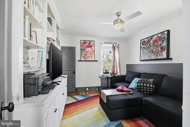 a living room with furniture and painting on the wall