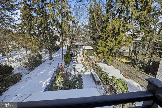 a view of a patio with table and chairs potted plants and wooden fence