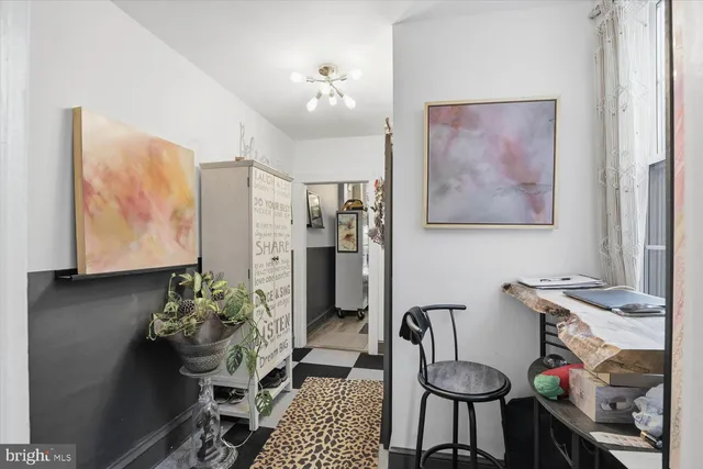 a view of a hallway with workspace and windows