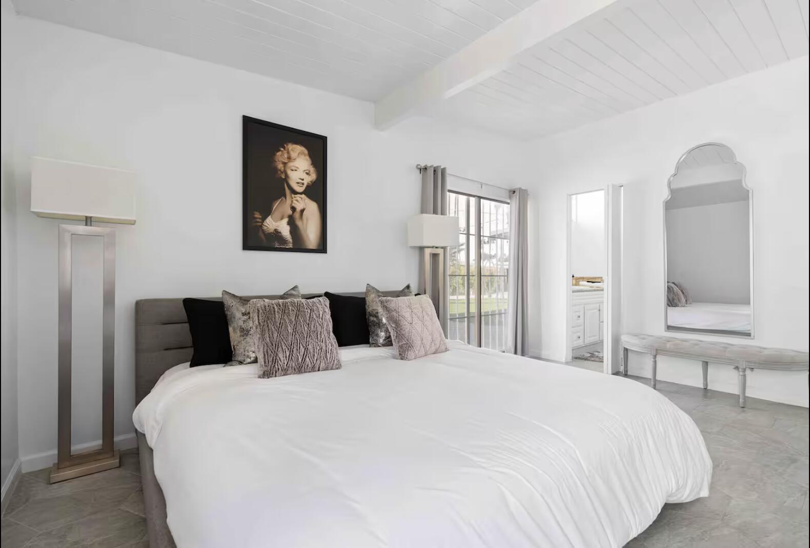 280 North Monterey Road Palm Springs, CA 92262 - Photo 12 of 29 a bedroom with a large bed and a chandelier