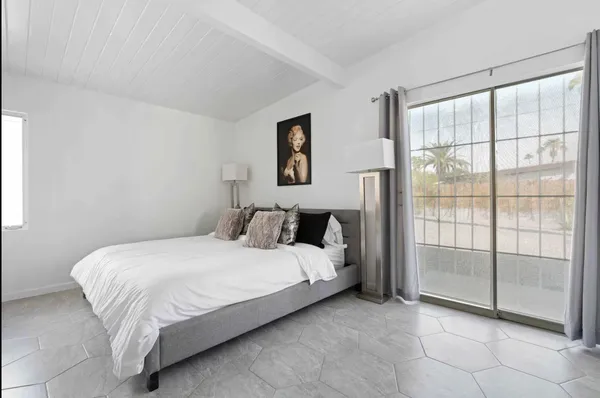 a bedroom with a bed and a window