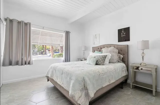 a bedroom with a bed and a window