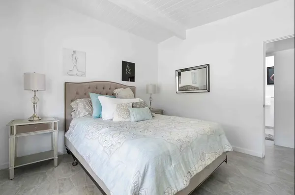 a bedroom with a bed and a night stand