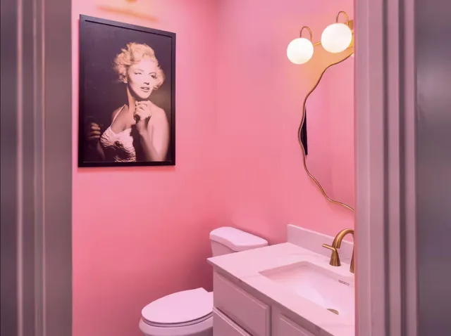a bathroom with a sink vanity mirror and toilet