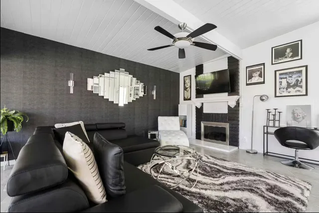 a living room with furniture a fireplace and a flat screen tv