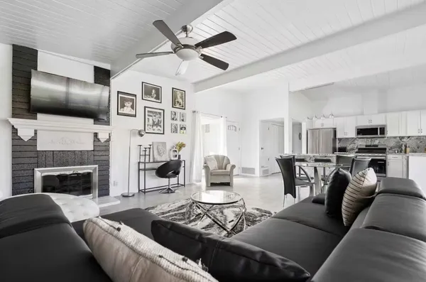a living room with furniture fireplace and flat screen tv