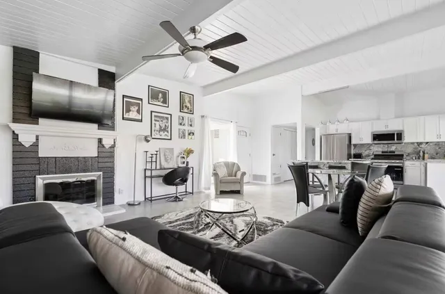 a living room with furniture fireplace and flat screen tv