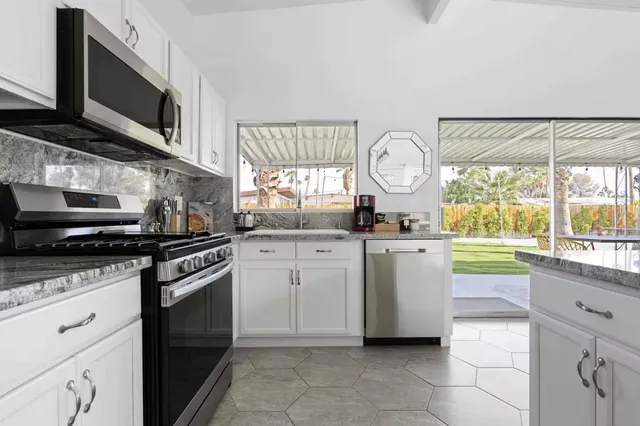 a kitchen with a stove a sink and a microwave
