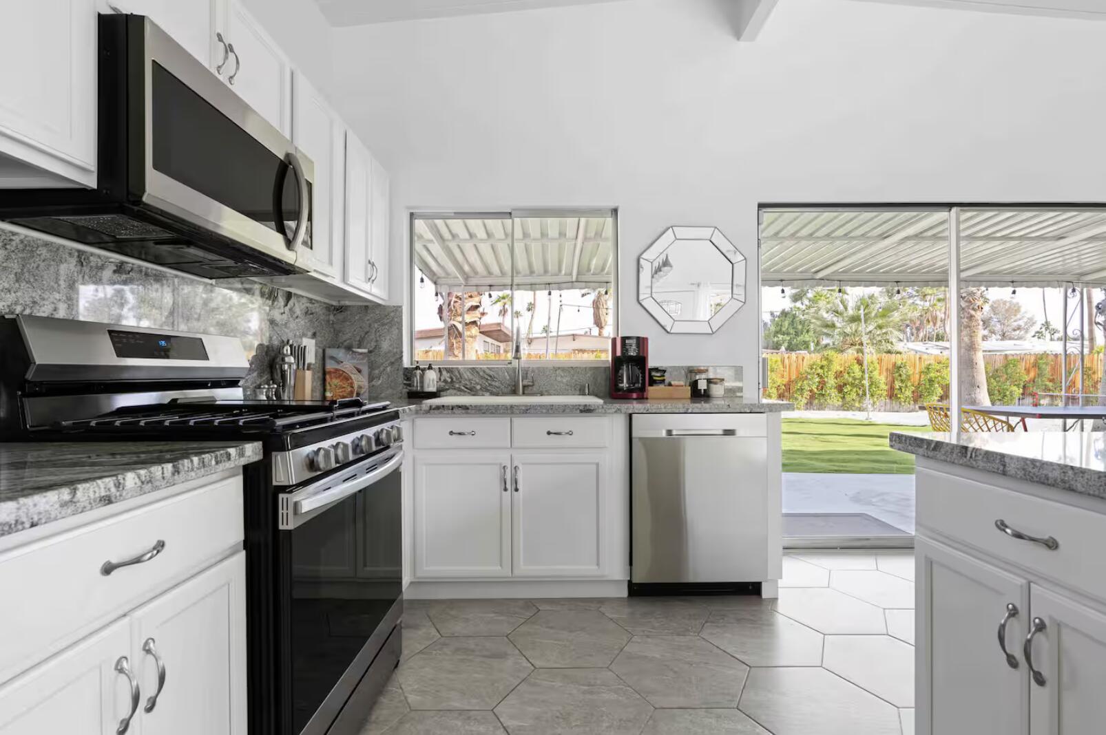 280 North Monterey Road Palm Springs, CA 92262 - Photo 9 of 29 a kitchen with a stove a sink and a microwave