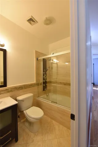 a bathroom with a toilet a sink and shower