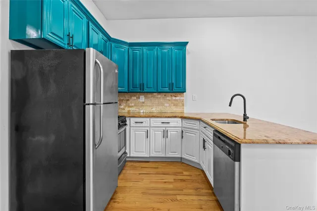 a kitchen with refrigerator and cabinets
