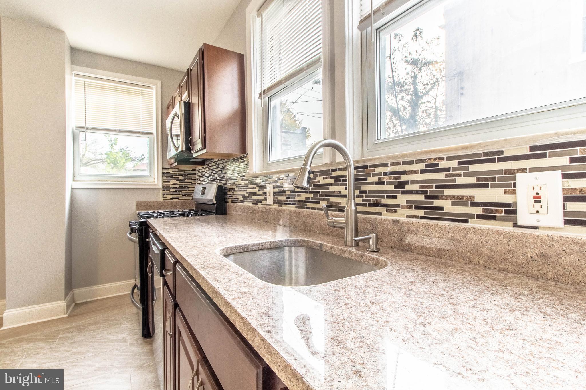 605 Benninghaus Road Baltimore, MD 21212 - Photo 11 of 30 a kitchen with granite countertop a sink and a window