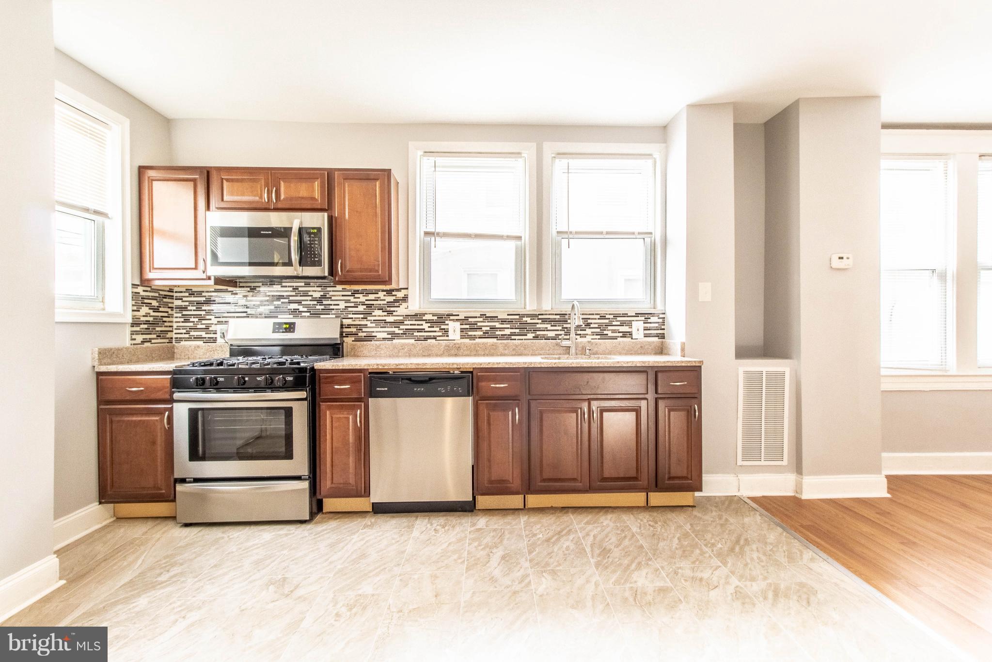 605 Benninghaus Road Baltimore, MD 21212 - Photo 12 of 30 a kitchen with stainless steel appliances granite countertop a stove a sink and a microwave