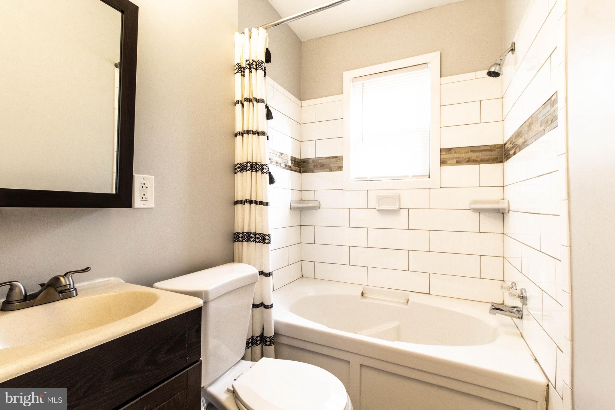 605 Benninghaus Road Baltimore, MD 21212 - Photo 23 of 30 a bathroom with a sink a toilet and shower