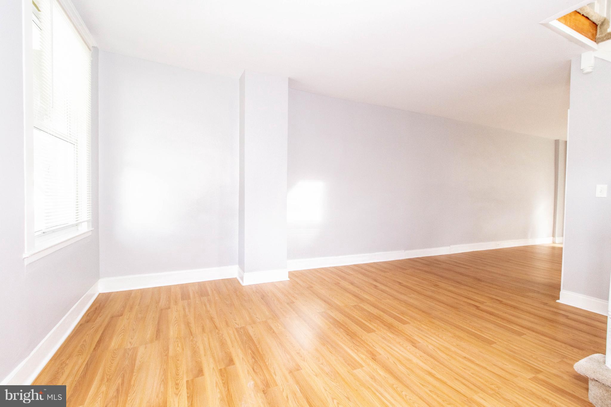 605 Benninghaus Road Baltimore, MD 21212 - Photo 6 of 30 a view of a room with wooden floor and a bathroom