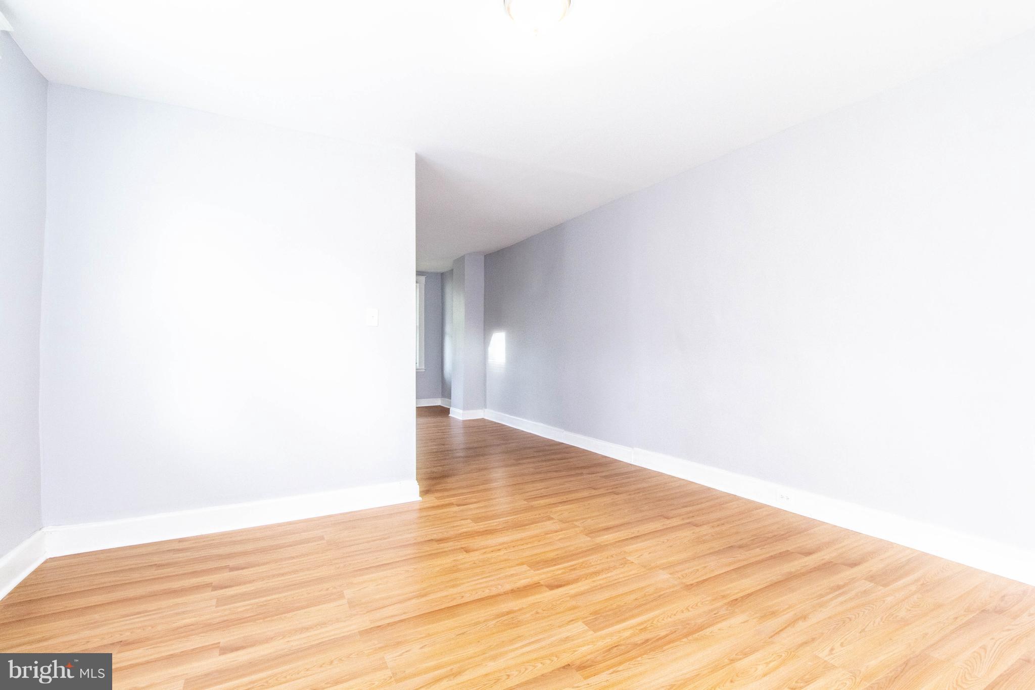 605 Benninghaus Road Baltimore, MD 21212 - Photo 7 of 30 a view of an empty room with wooden floor