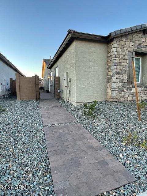 9625 West Monterey Way, Unit B Phoenix, AZ 85392 - Photo 18 of 22 a front view of a house with garden