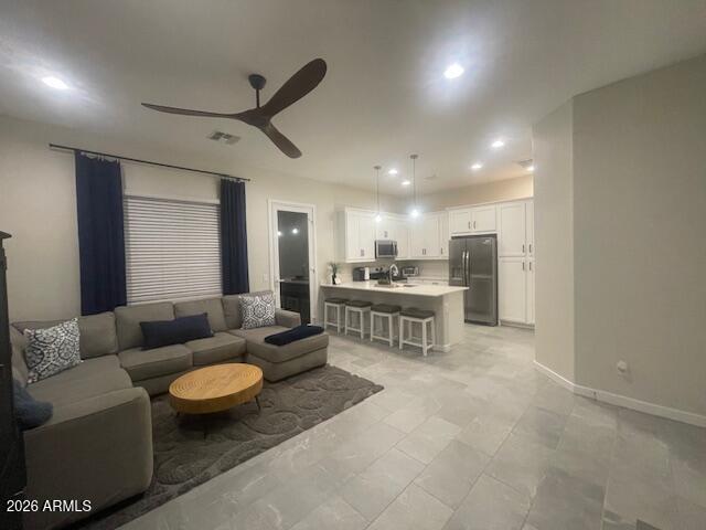 9625 West Monterey Way, Unit B Phoenix, AZ 85392 - Photo 3 of 22 a living room with furniture and a table