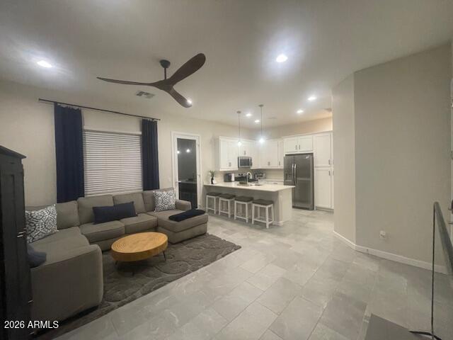 9625 West Monterey Way, Unit B Phoenix, AZ 85392 - Photo 4 of 22 a living room with furniture and a view of kitchen