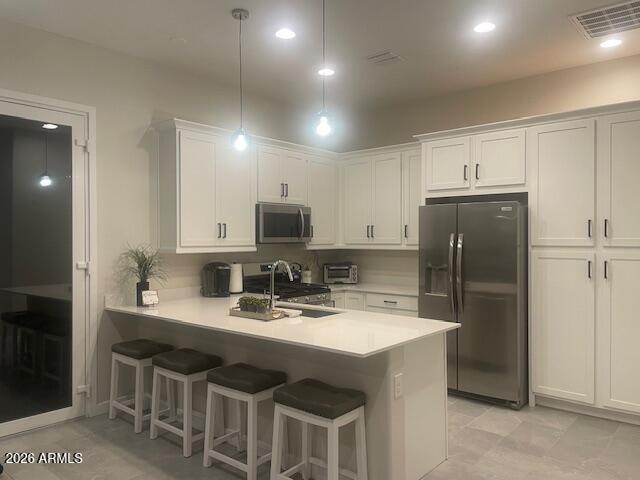 9625 West Monterey Way, Unit B Phoenix, AZ 85392 - Photo 8 of 22 a kitchen with kitchen island appliances a sink cabinets and a counter top space