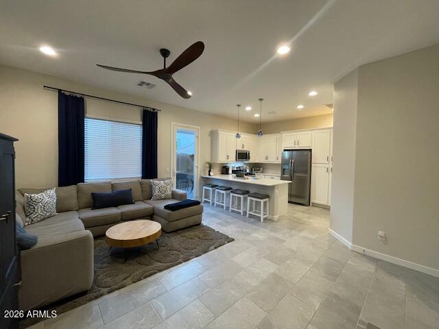 9625 West Monterey Way, Unit B Phoenix, AZ 85392 - Photo 9 of 22 a living room with couches and kitchen view with wooden floor