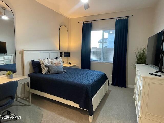 9625 West Monterey Way, Unit B Phoenix, AZ 85392 - Photo 10 of 22 a bedroom with a bed and a flat tv screen on dresser