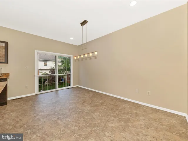 a view of a room with furniture and wooden floor